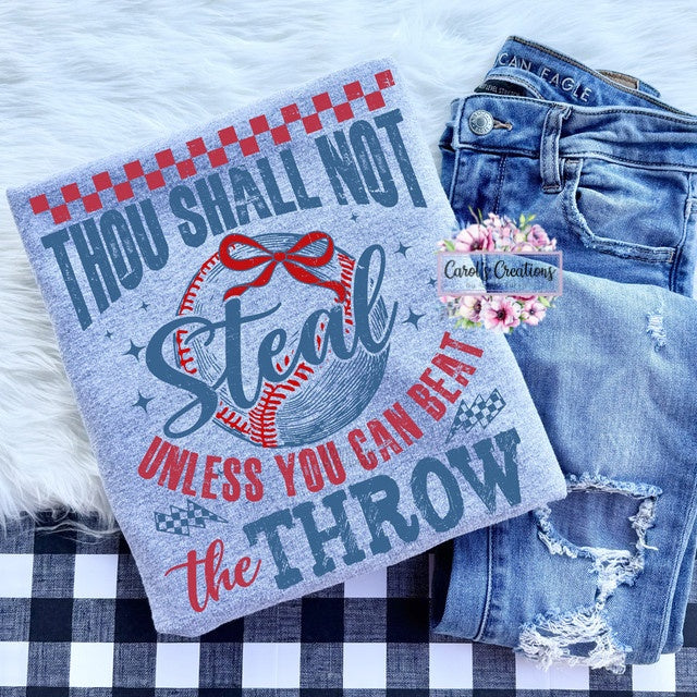 Towel with sports-themed text and graphics on a checkered surface with jeans.