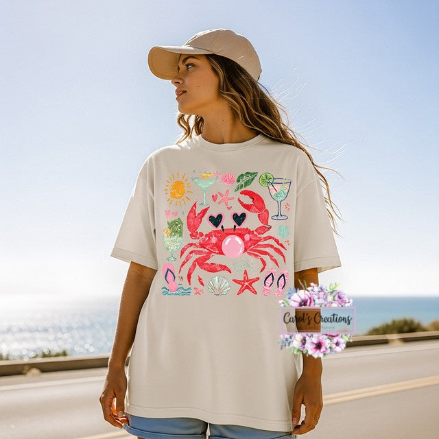 Woman wearing a t-shirt with a colorful crab design outdoors.