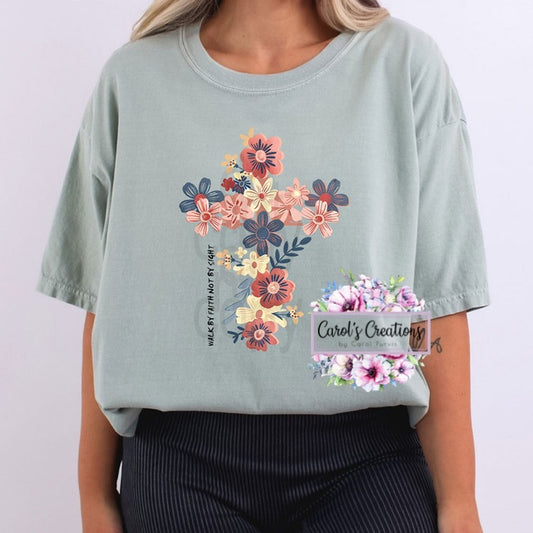 Light blue t-shirt with floral design and text on a plain background